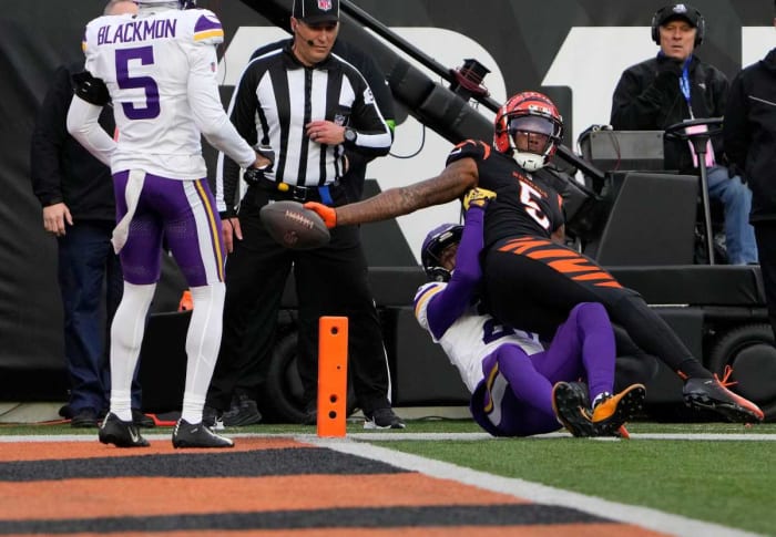 Cincinnati Bengals wide receiver Tee Higgins (5) makes a touchdown over Minnesota Vikings cornerback Akayleb Evans (21) in the 4th quarter Paycor Stadium Saturday, December 16, 2023.